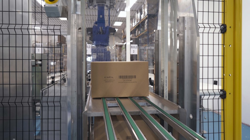 Automated warehouse robots moving inventory through a production line