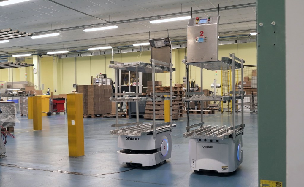 Automated warehouse robots transporting product packs at Diva International