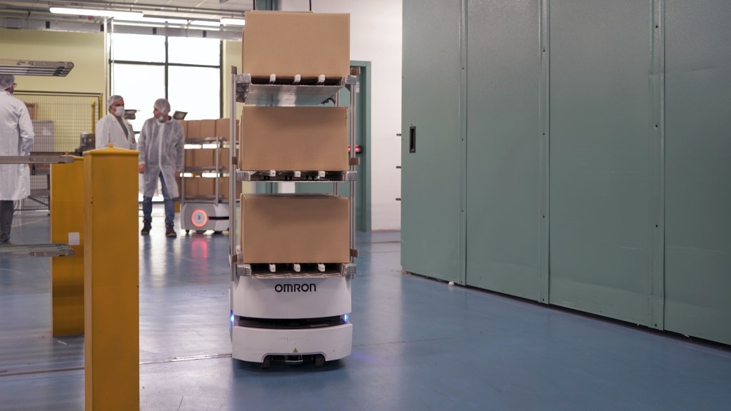 Automated warehouse robots working alongside staff at Diva