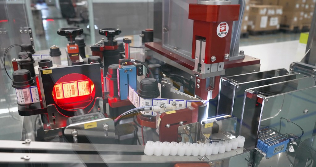 OMRON FHV7 smart vision system ensuring accurate barcode placement in automated vial labelling