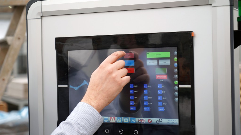 Operator setting up automated labelling process for packages
