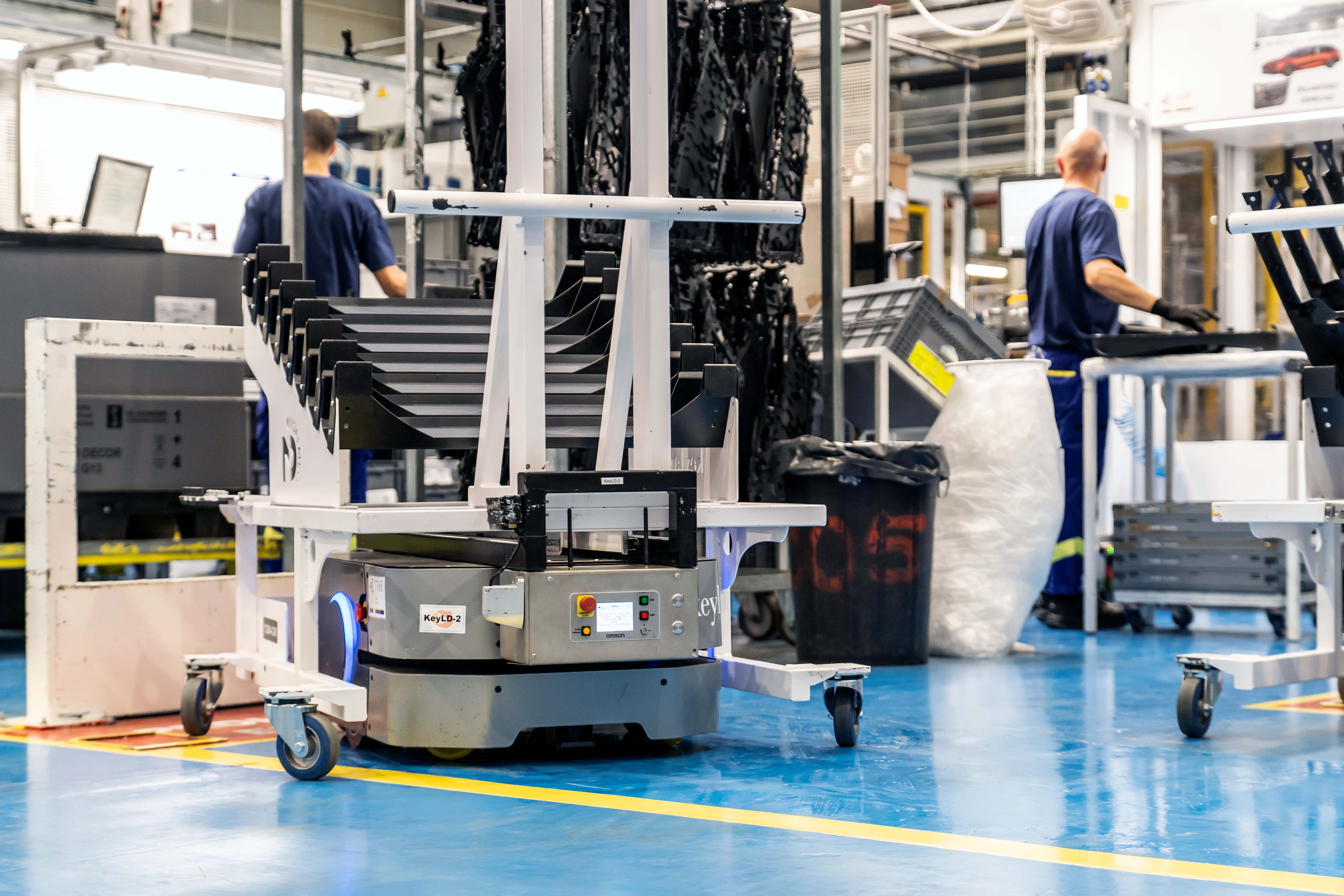 Operators collaborating with robots in automotive manufacturing automation