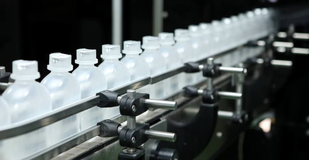 OMRON SCARA i4L robot in MACCO automated packaging line inserting bottles