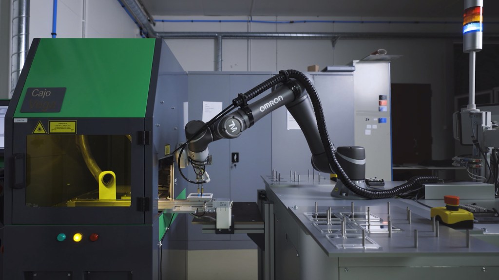 Cobot performing machine tending automation at laser marking station