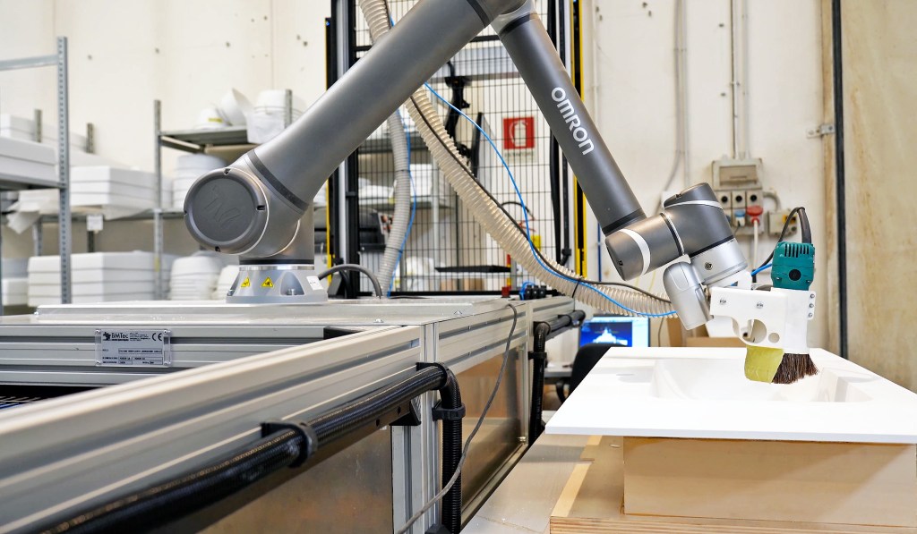 Cobot precisely removing acrylic glue band from sink rim