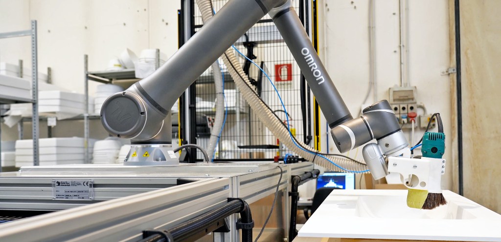 Cobot precisely removing acrylic glue band from sink rim_crop