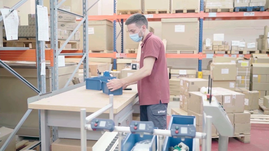 Employee using AMR warehouse automation for efficient material handling
