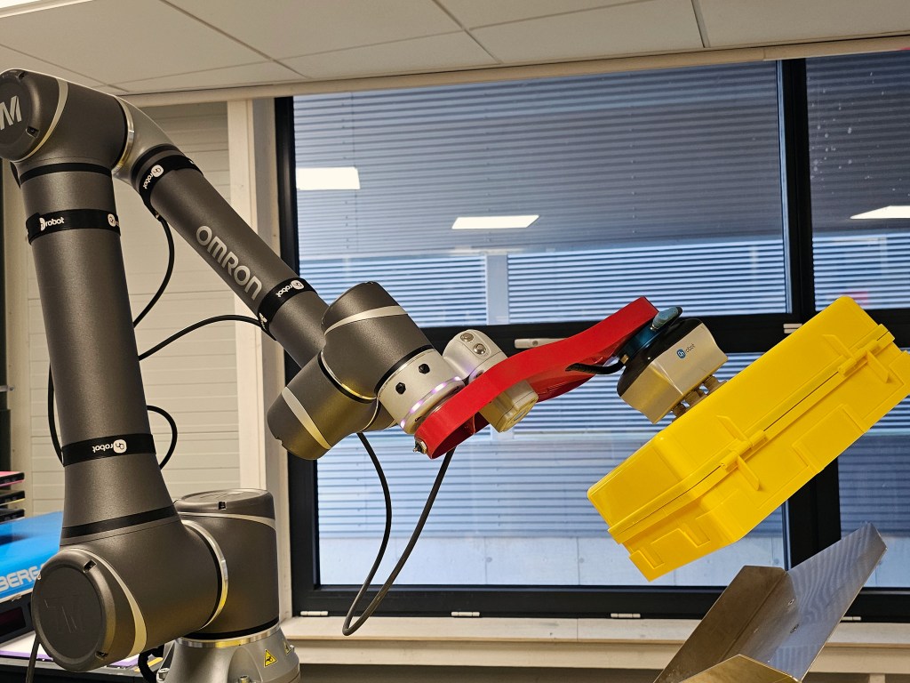 Medical kit being placed onto pallets by robotic arm
