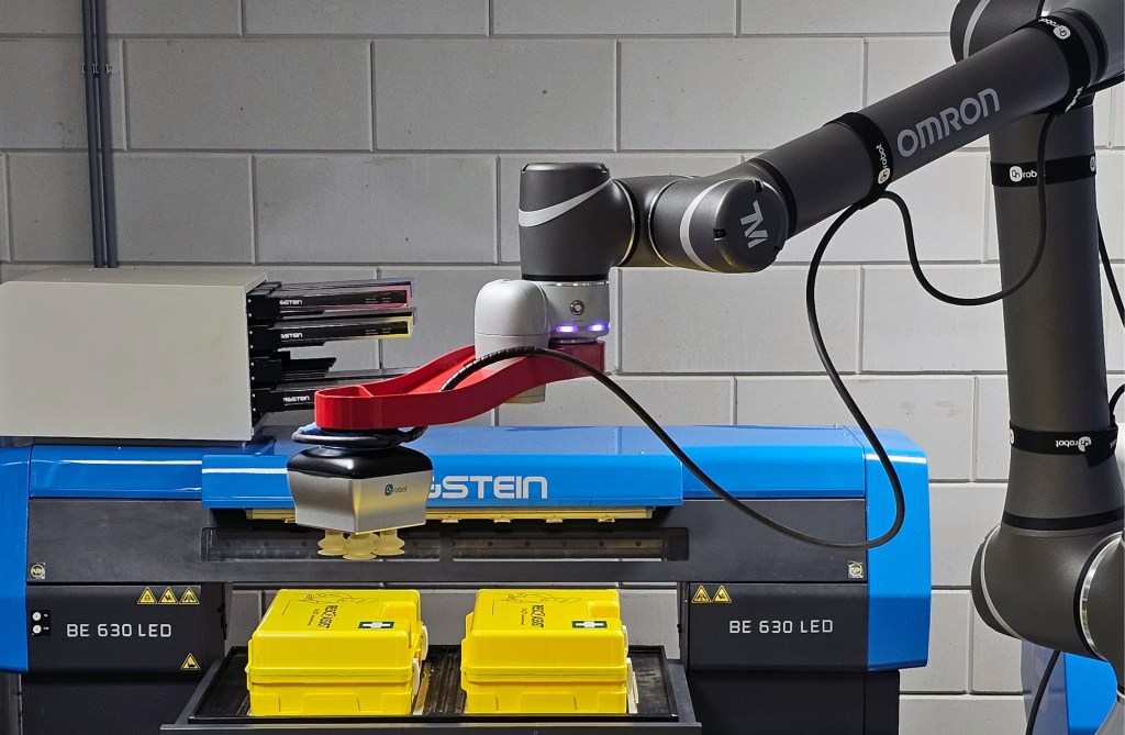 OMRON collaborative robot handling medical first aid kit boxes