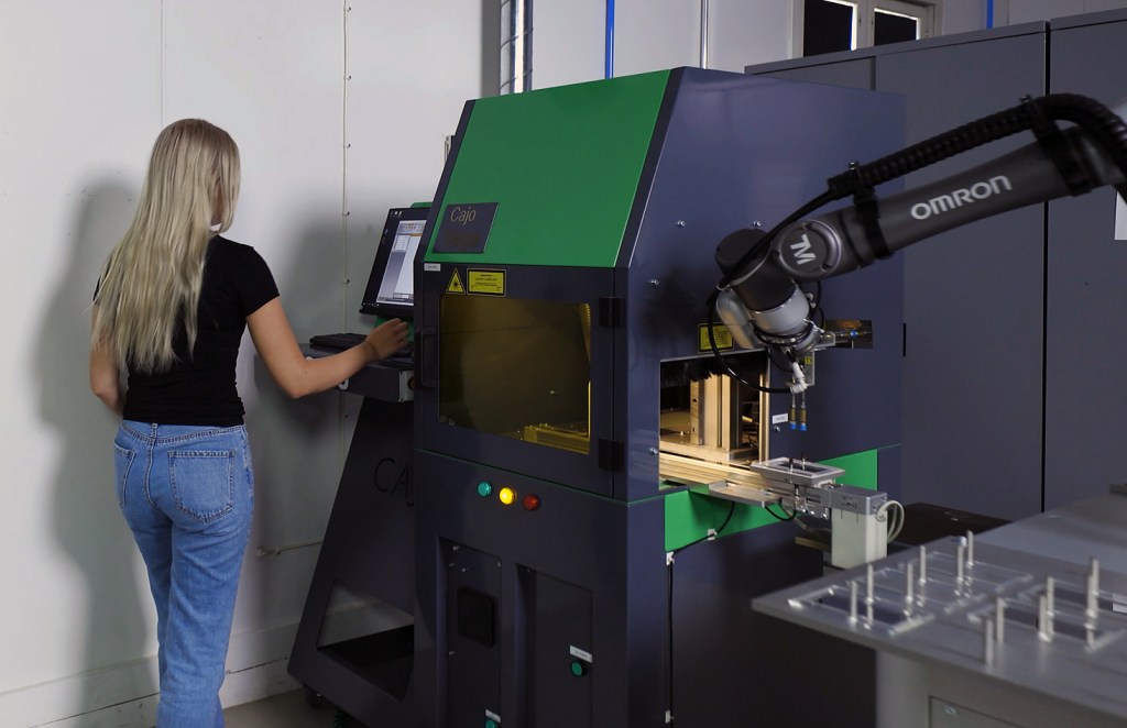 Operator overseeing collaborative robot during tending process