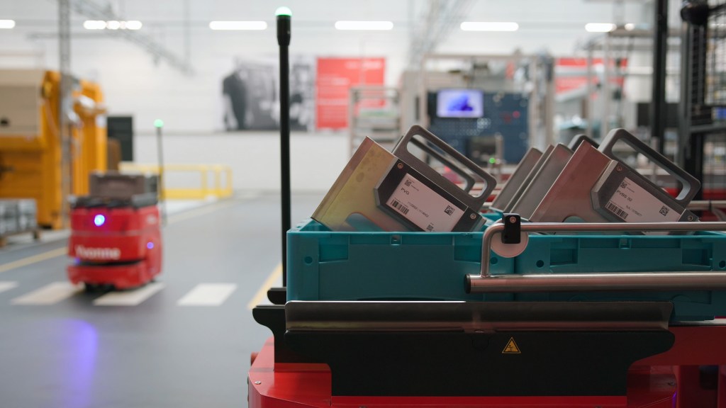Autonomous warehouse robots transporting parts at Danfoss Power Solutions